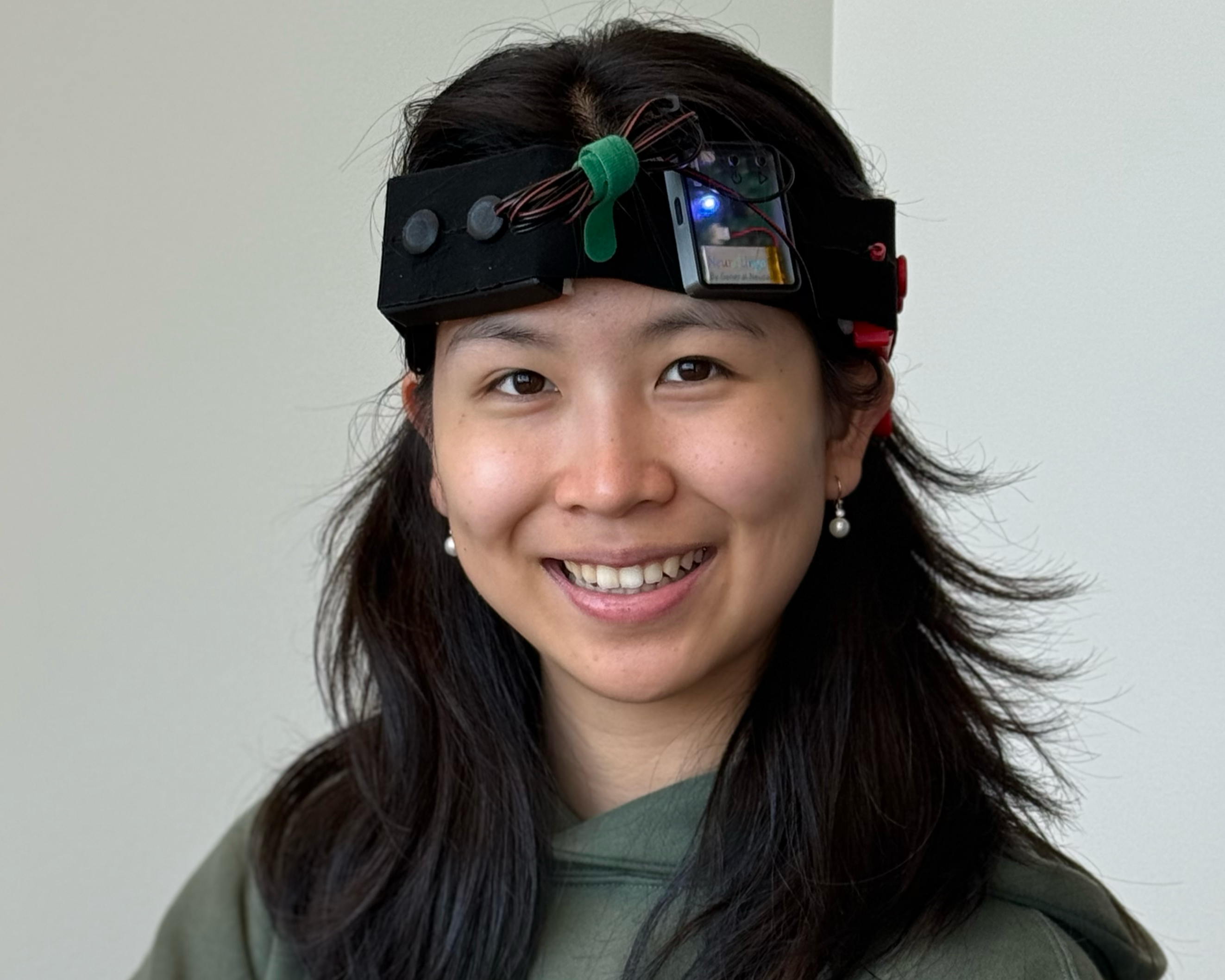 Person wearing the NeuroLingo Model 1 smiling indoors.