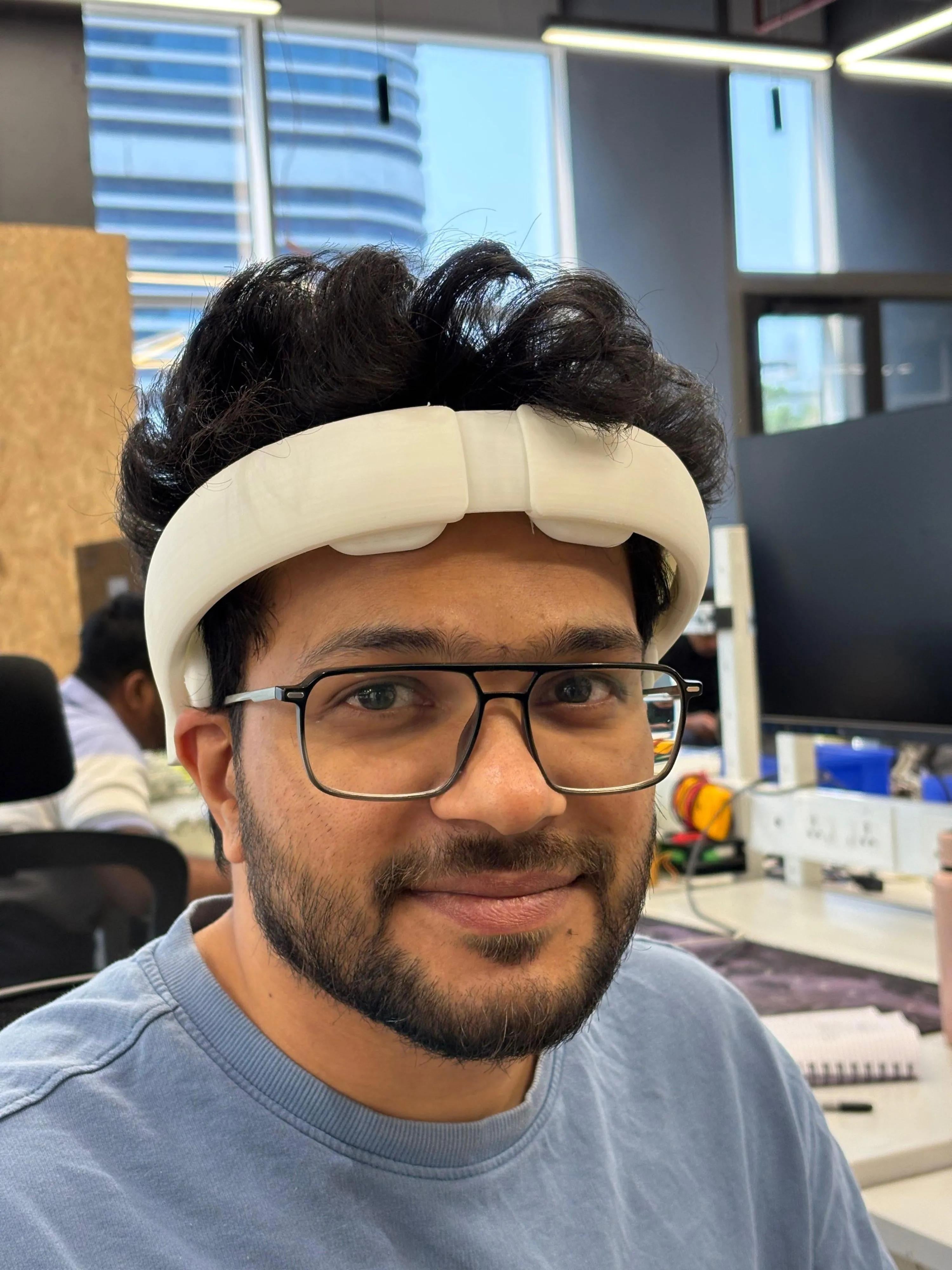 Next-generation General Neuroscience tES headset: a sleek 3D-printed white band, contoured to the head, with the electronics tucked inside the form