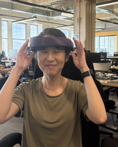 A team member adjusting the v5 NeuroLingo headset with both hands