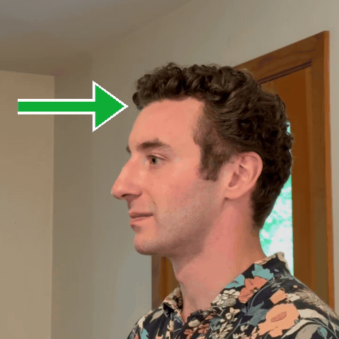 Animation of putting the headset on from the front, with an arrow showing the direction of motion