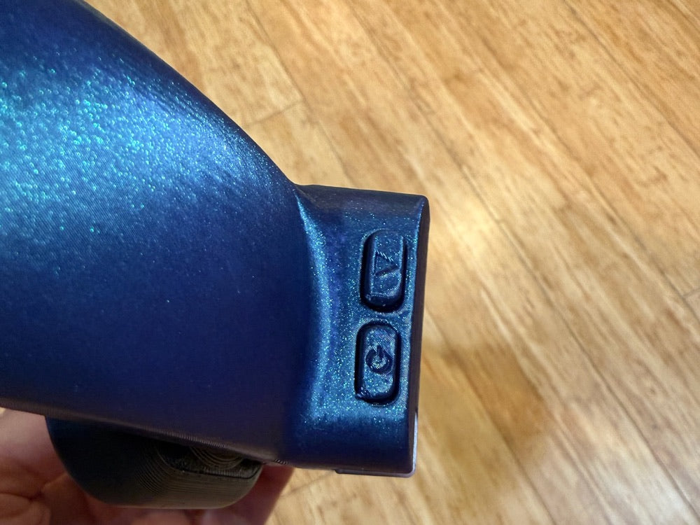 Underside of the NeuroLingo Pro control arm with two buttons; the power button is circled