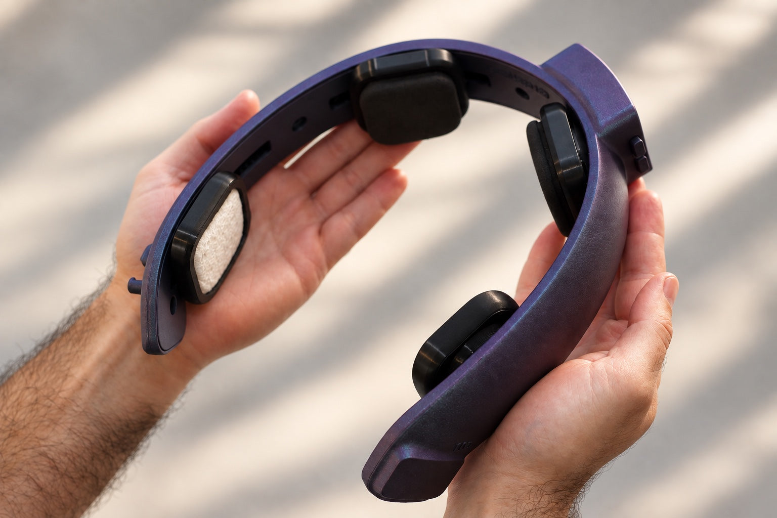 Two hands holding the NeuroLingo headband