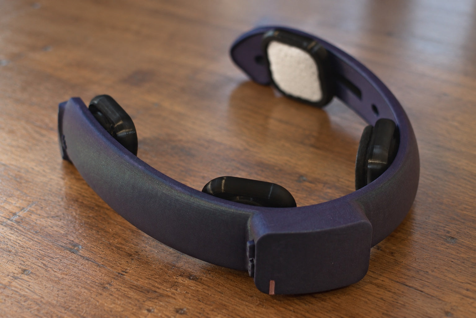 The NeuroLingo headband resting on a wooden table