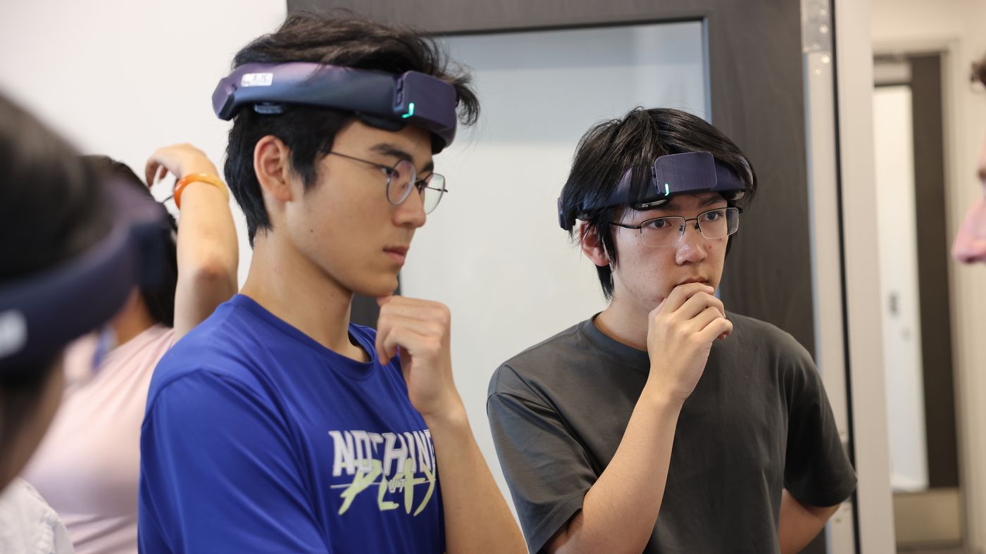 Two Virginia Tech trial participants wearing NeuroLingo headbands